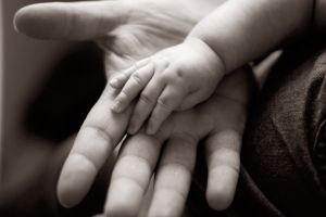 A baby's hand on an adult hand