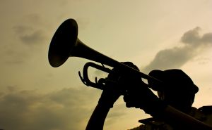 Silhouette of person doing a bugle call