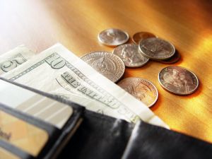 Coins and paper money spilling out of wallet
