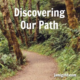 Dirt path through trees and ferns with text: Discovering Our Path