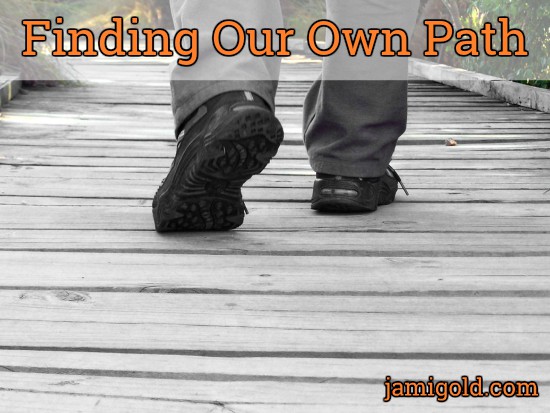 Close up of shoes crossing wooden footbridge with text: Finding Our Own Path