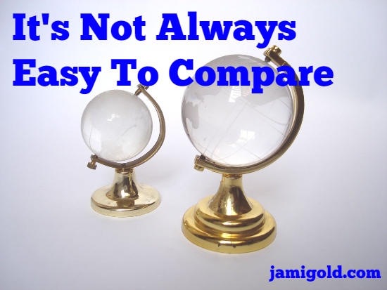 Small glass globe beside large glass globe with text: It's Not Always Easy To Compare